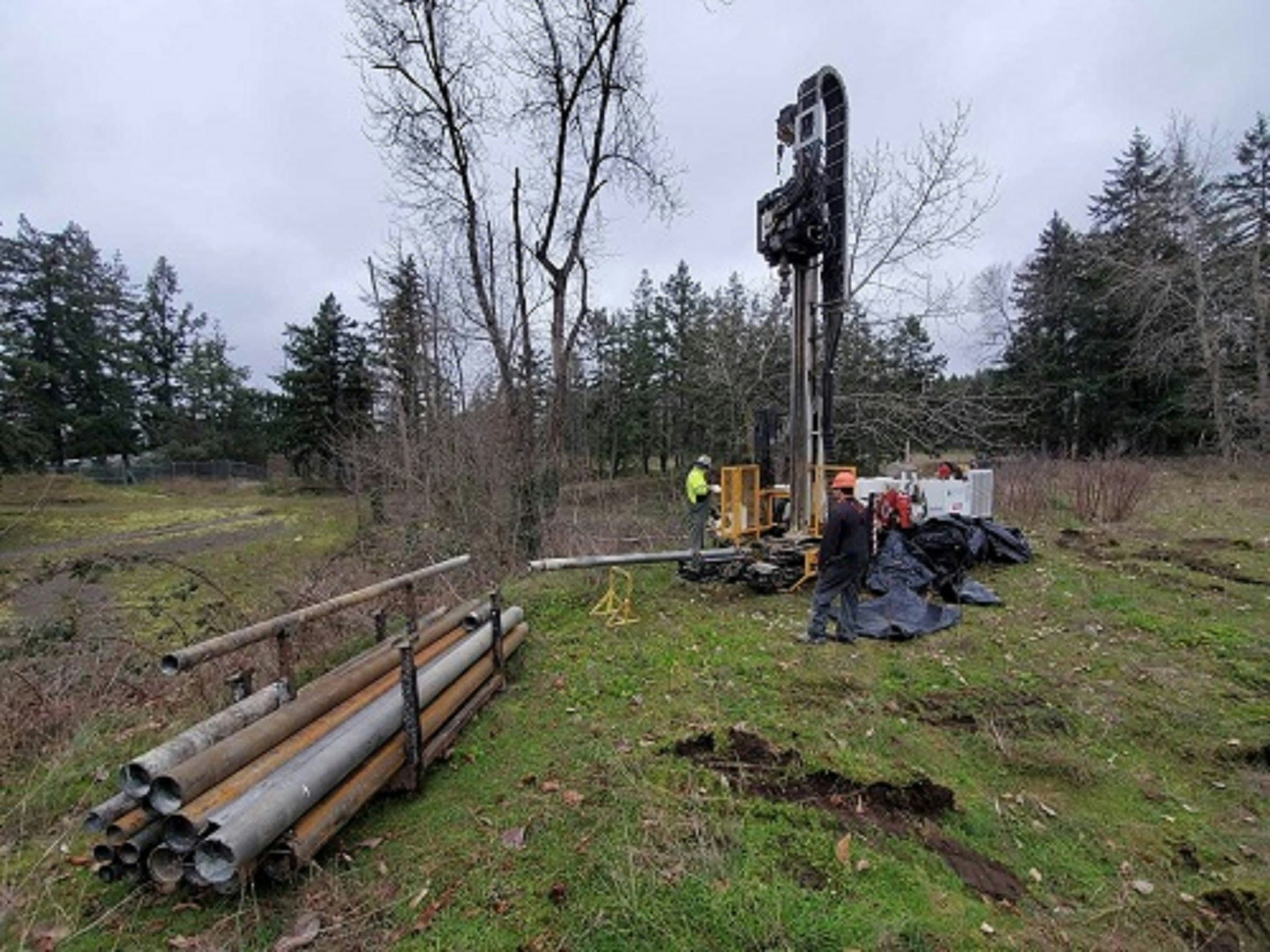Borehole drilling rig and casing pipes on a site investigation