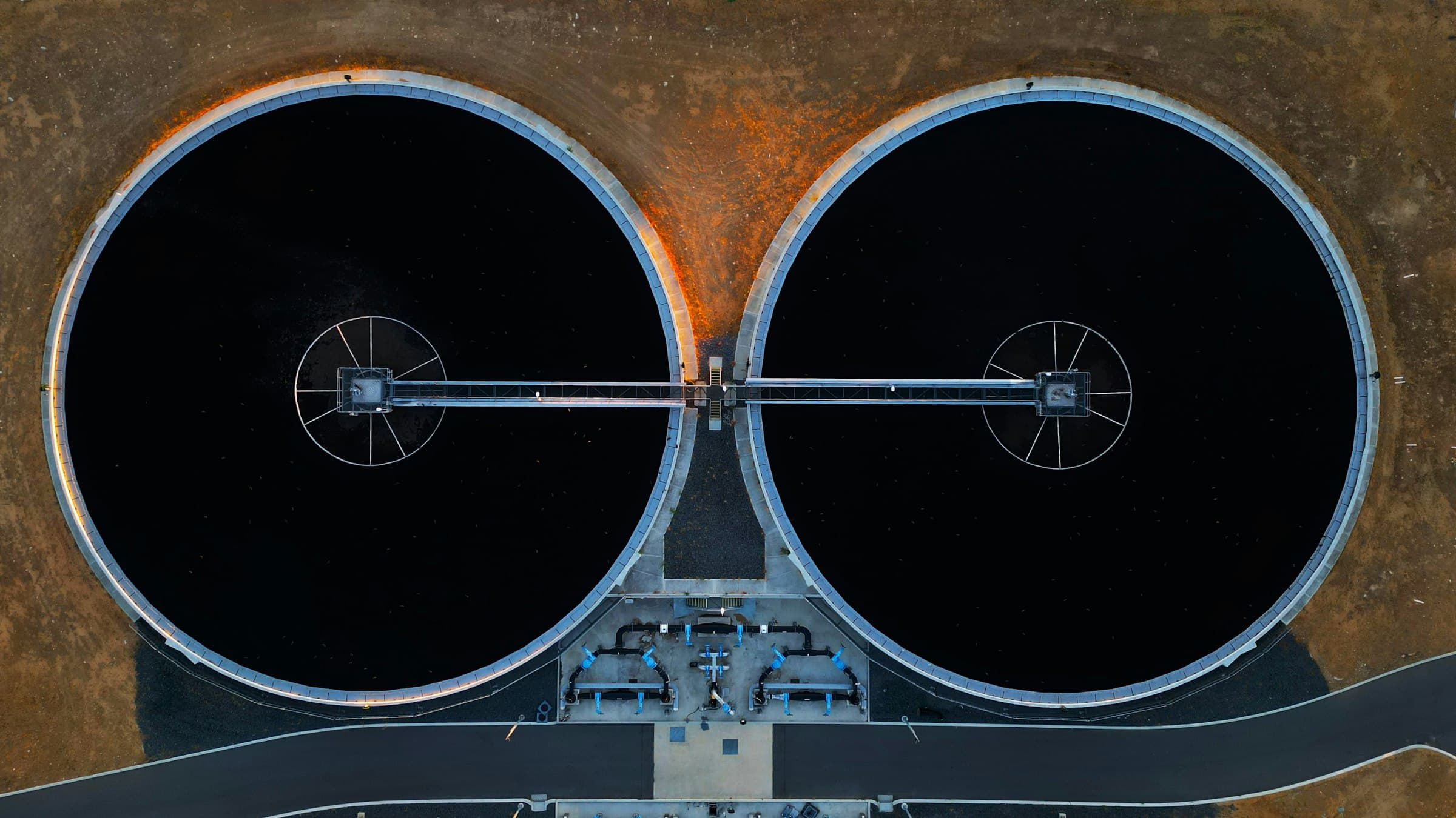 Twin circular clarifiers at a water treatment plant, seen from above