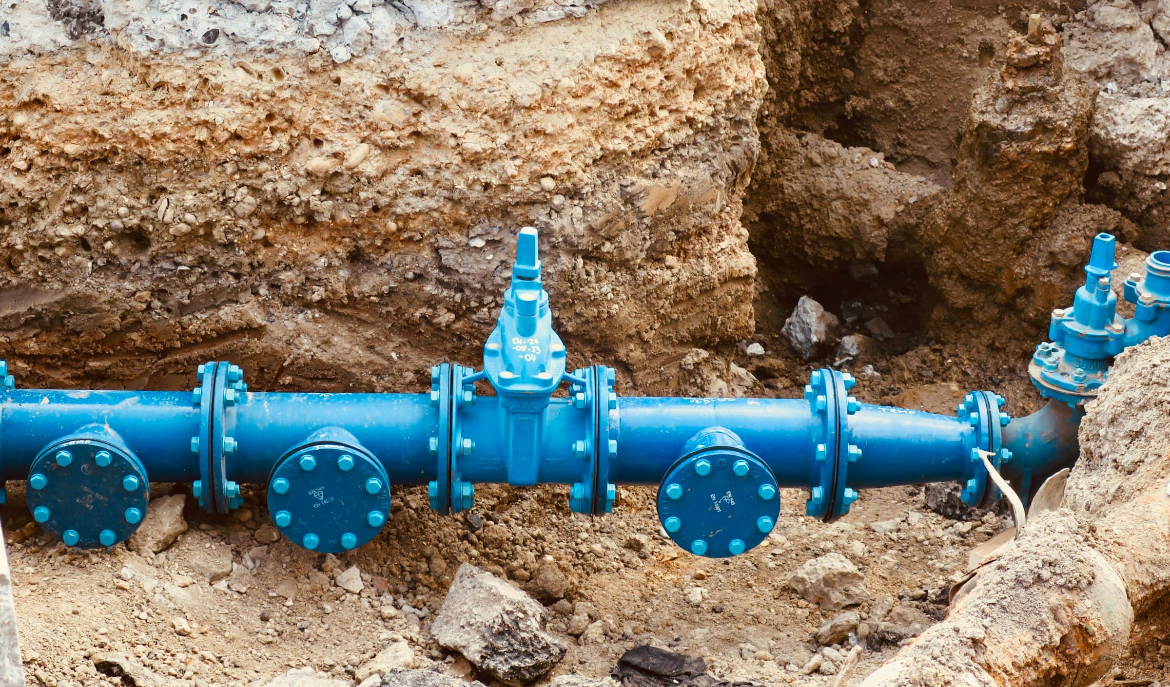 Water main with gate valves exposed in an open excavation