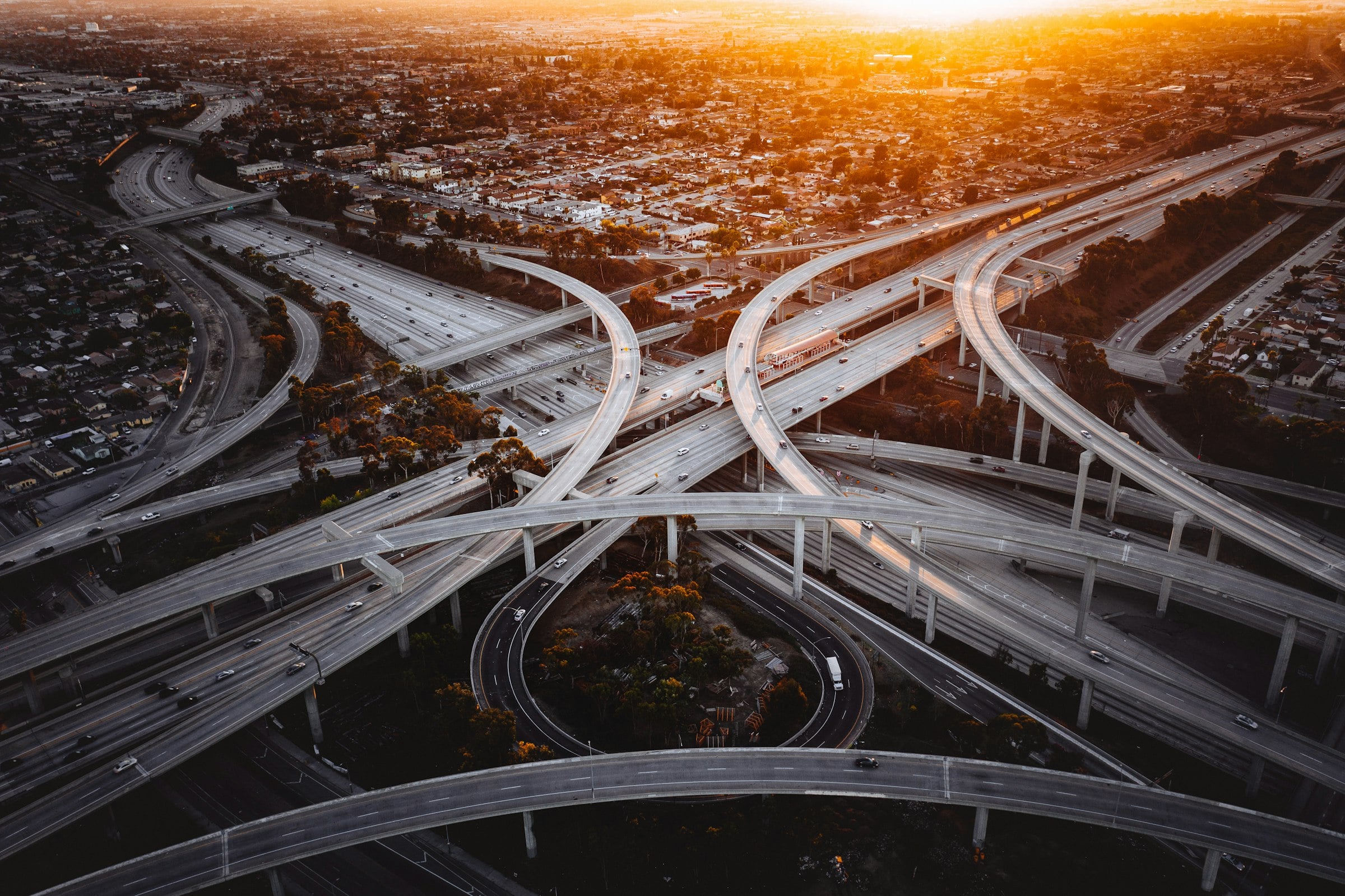 Multi-level highway interchange at dusk, seen from the air